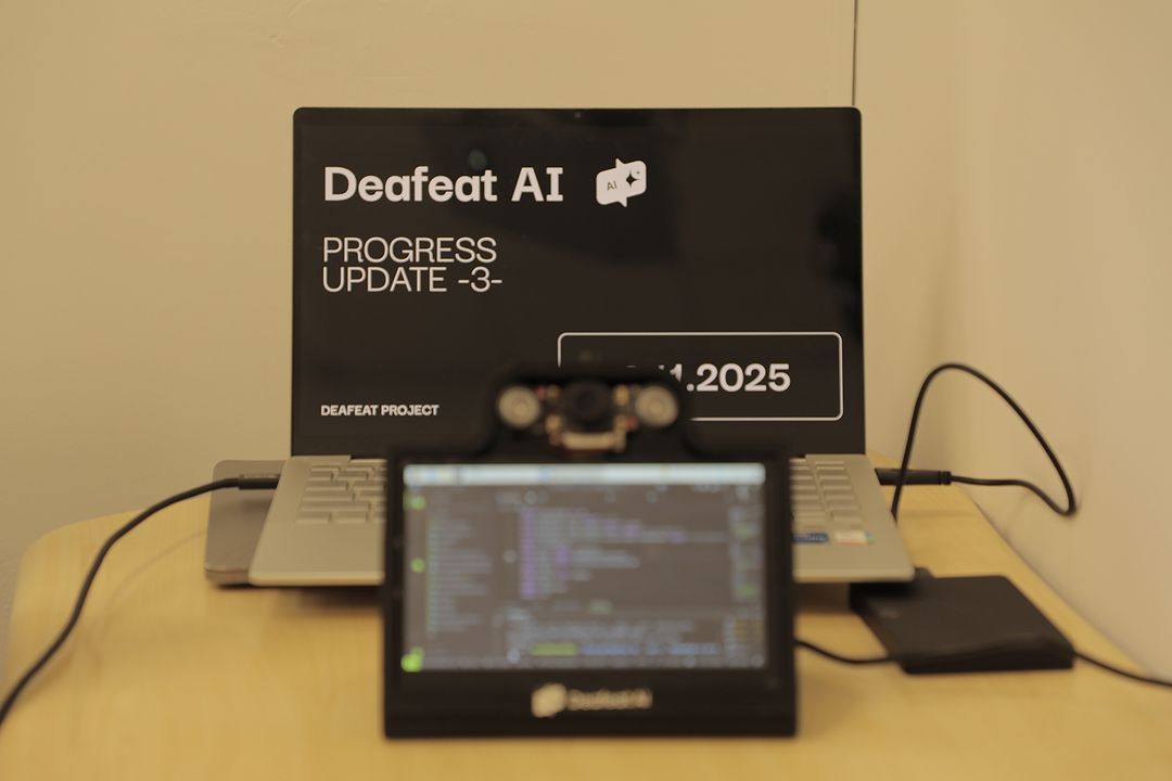 The Deafeat AI device: a camera and sensor module next to a progress-update slide